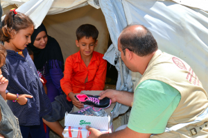 Children receiving shoes